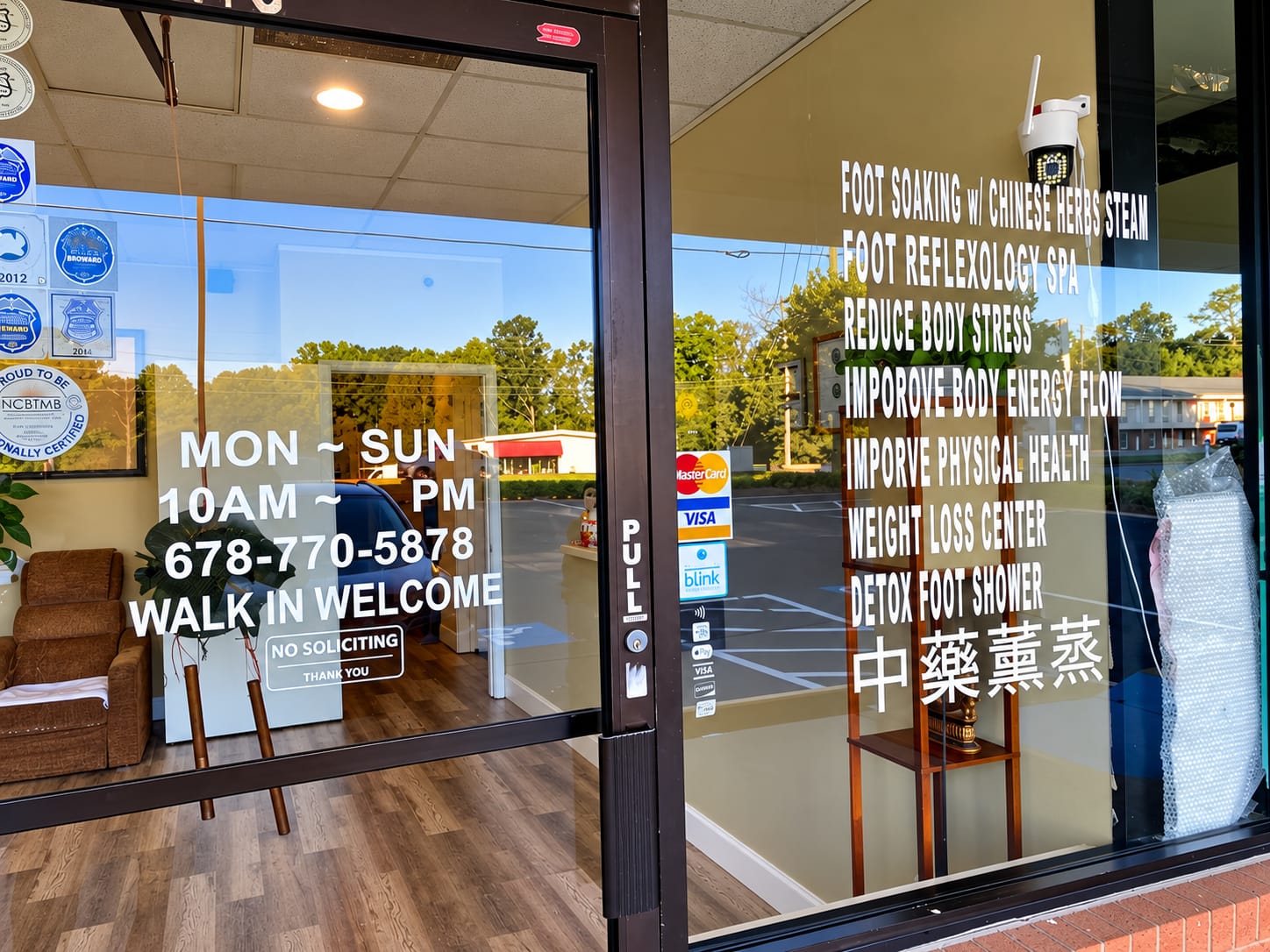 Jojo's Massage Main St entrance door with certifications and services
